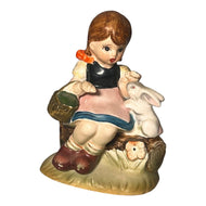 Little girl with Kewpie doll figurine. Occupied Japan