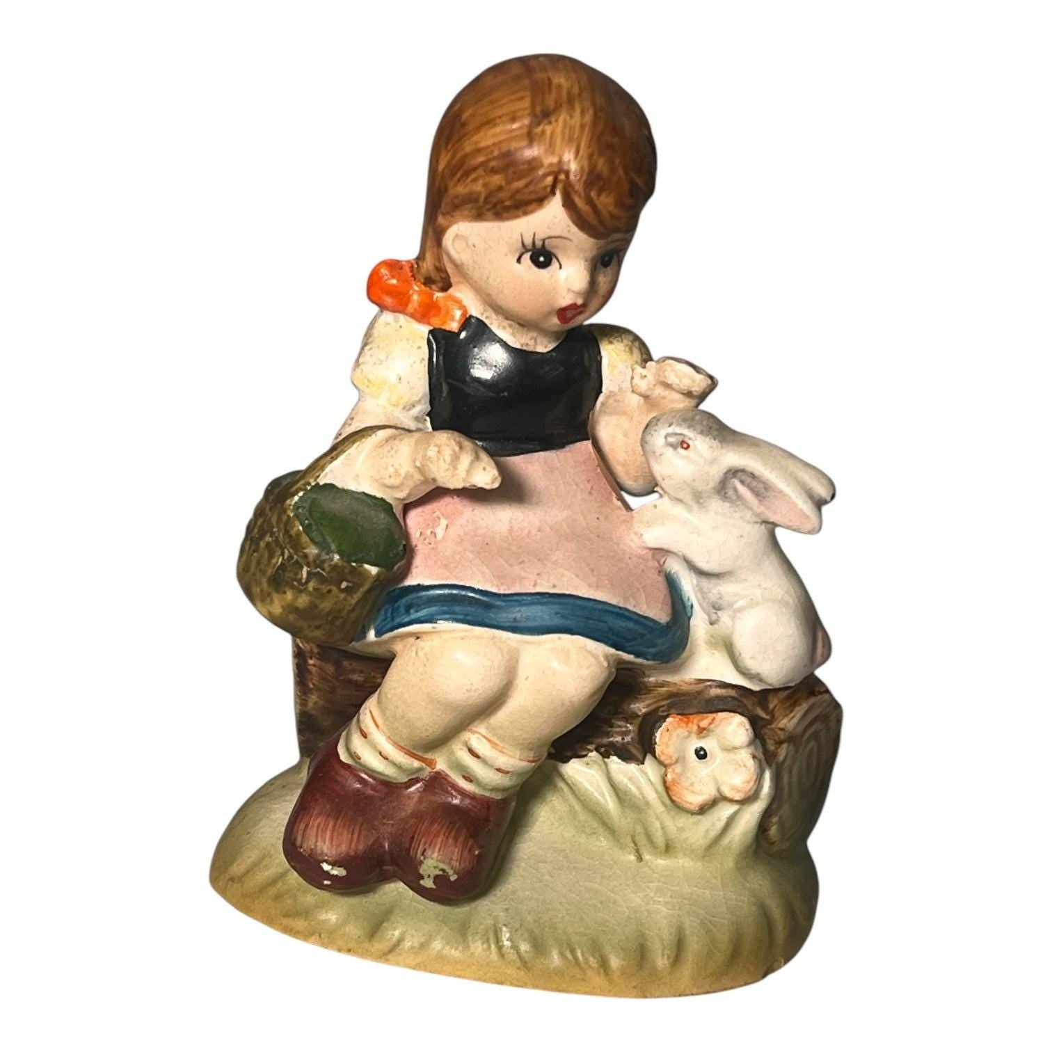 Little girl with Kewpie doll figurine. Occupied Japan