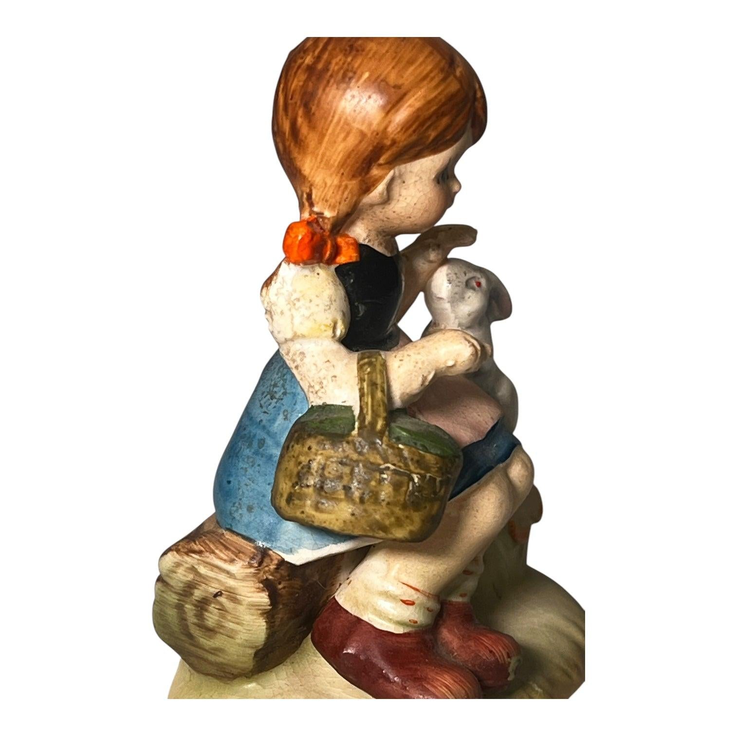 Little girl with Kewpie doll figurine. Occupied Japan