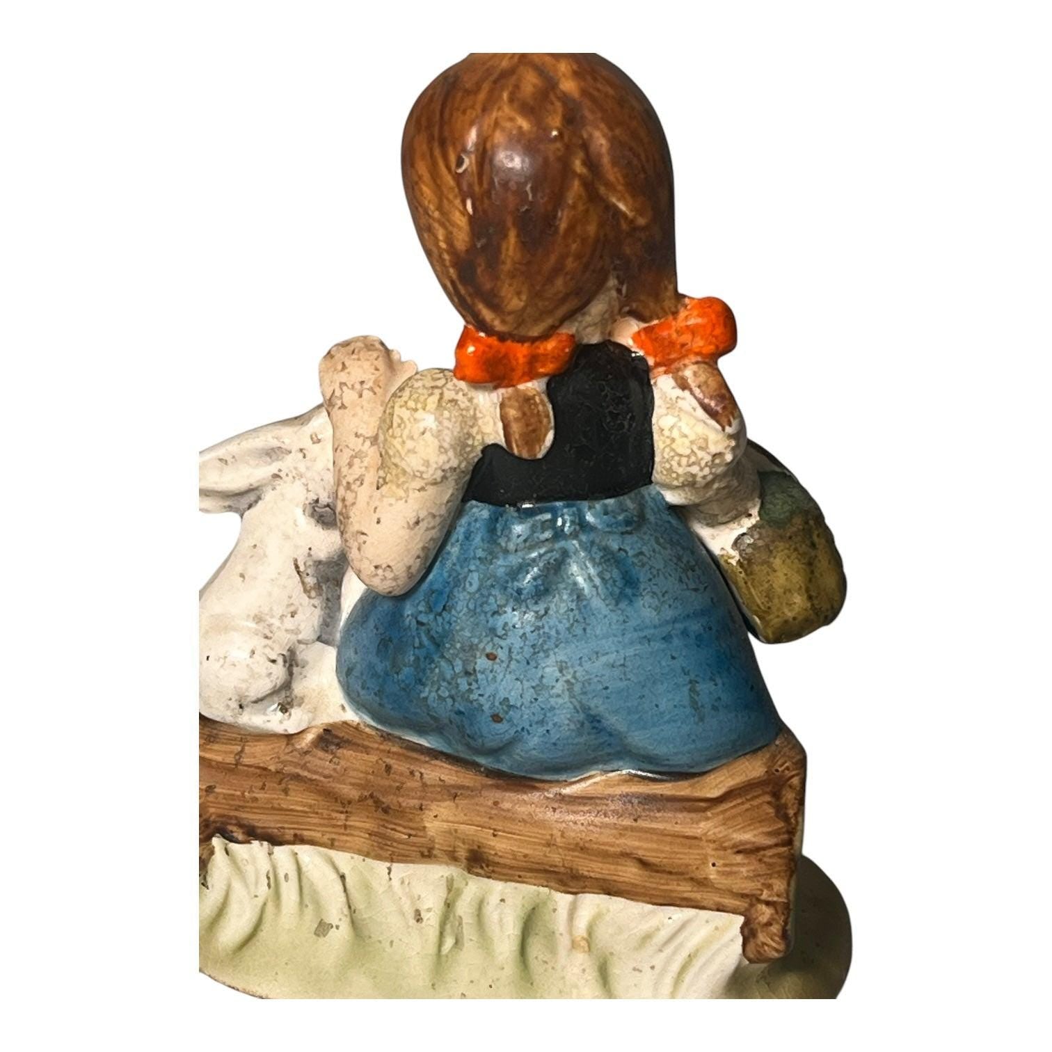 Little girl with Kewpie doll figurine. Occupied Japan